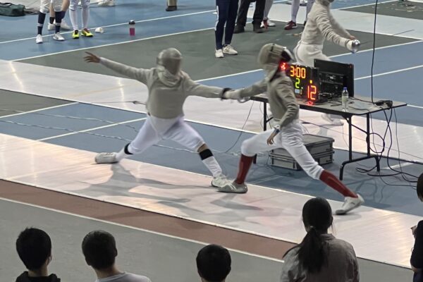 Vito actively participating in a fencing tournament.