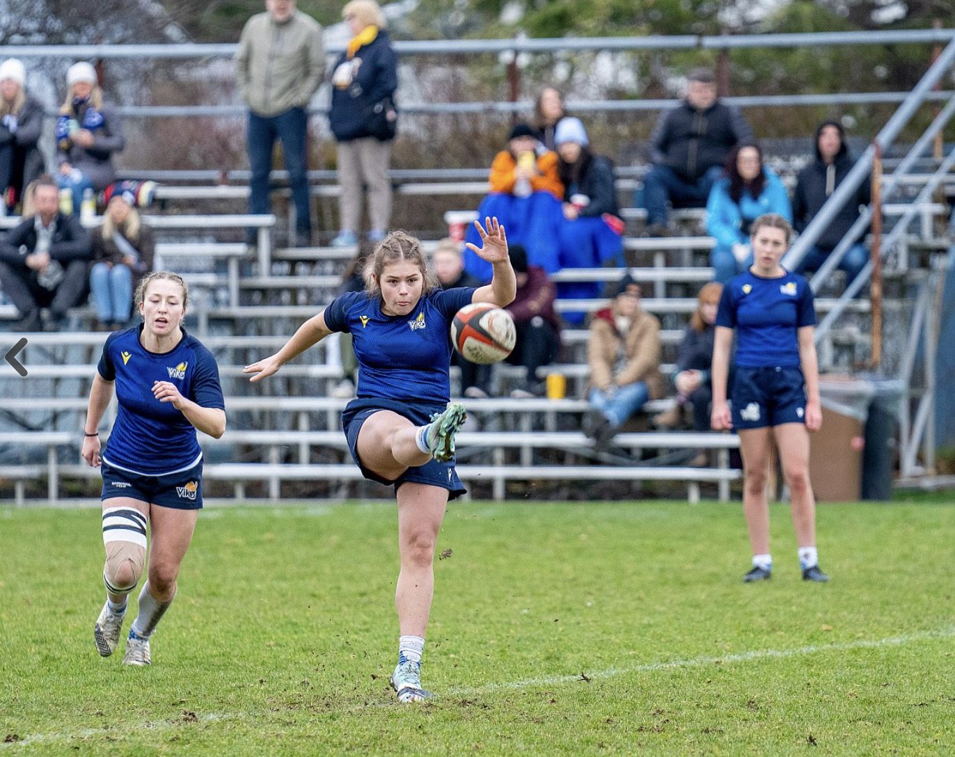 Olivia kicking the rugby ball.